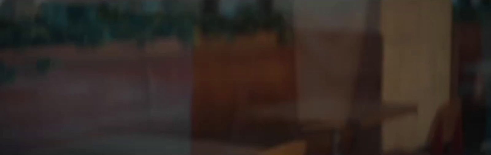 a blurry photo of a building with trees in the background