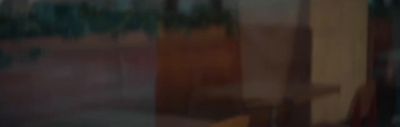 a blurry photo of a building with trees in the background