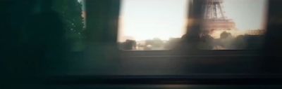 a blurry picture of the eiffel tower seen through a window