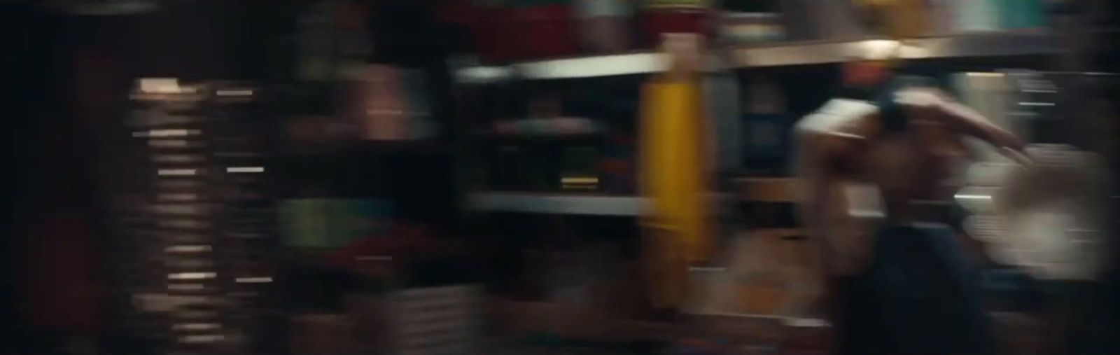 a blurry photo of a person standing in front of a bookshelf