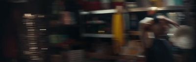 a blurry photo of a person standing in front of a bookshelf