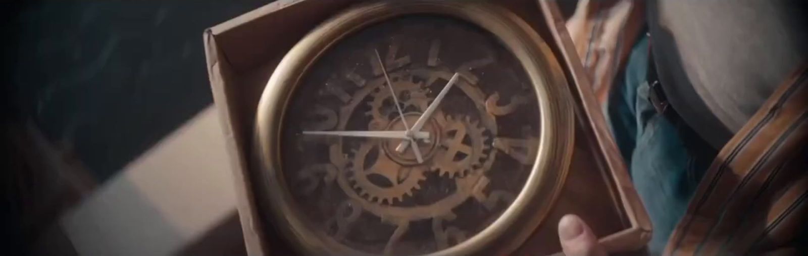 a person holding a clock in their hand