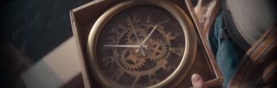 a person holding a clock in their hand