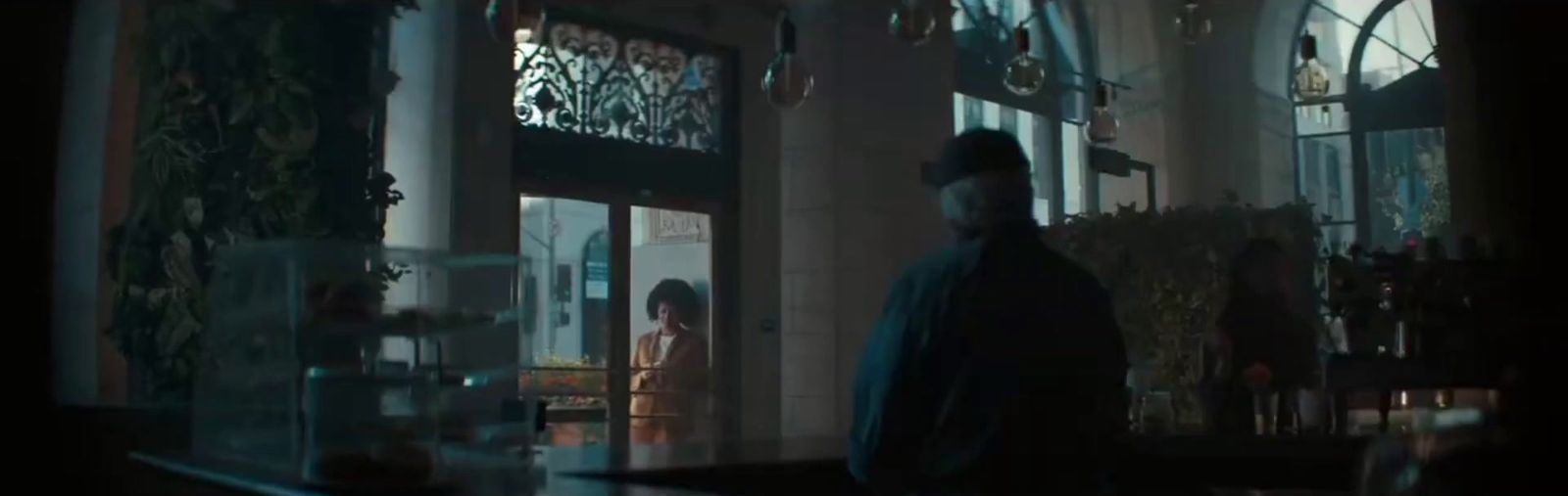 a man standing in front of a building at night