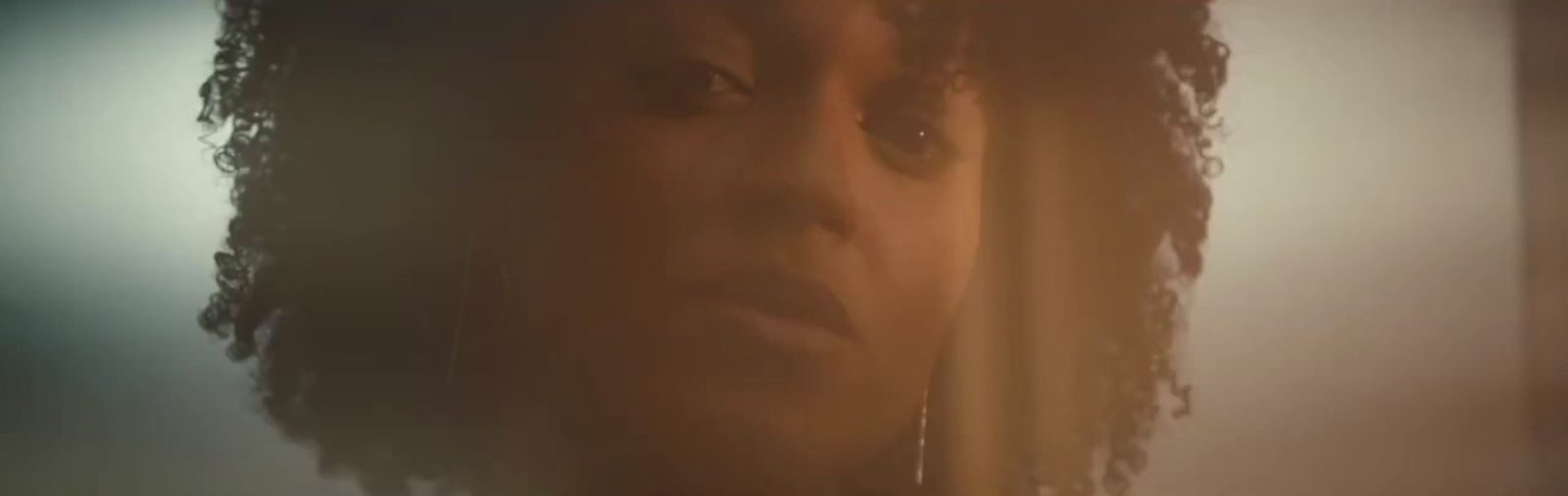 a close up of a person with curly hair