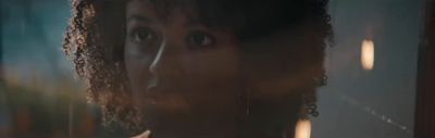 a close up of a person with curly hair