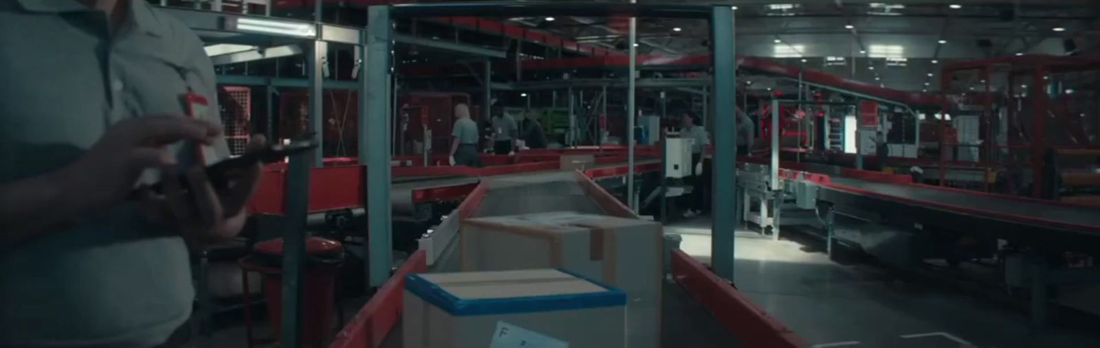 a man standing in a warehouse next to boxes