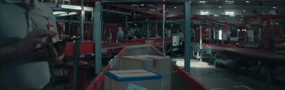 a man standing in a warehouse next to boxes