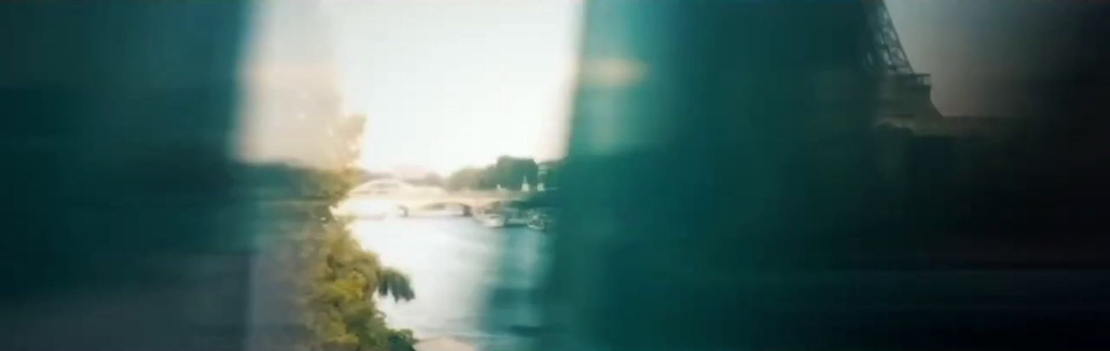 a blurry photo of a city street and a river
