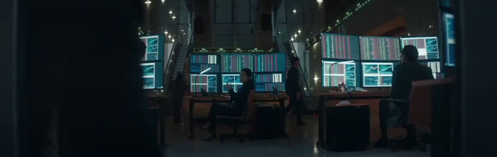a person standing in a room with lots of windows