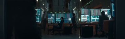a person standing in a room with lots of windows