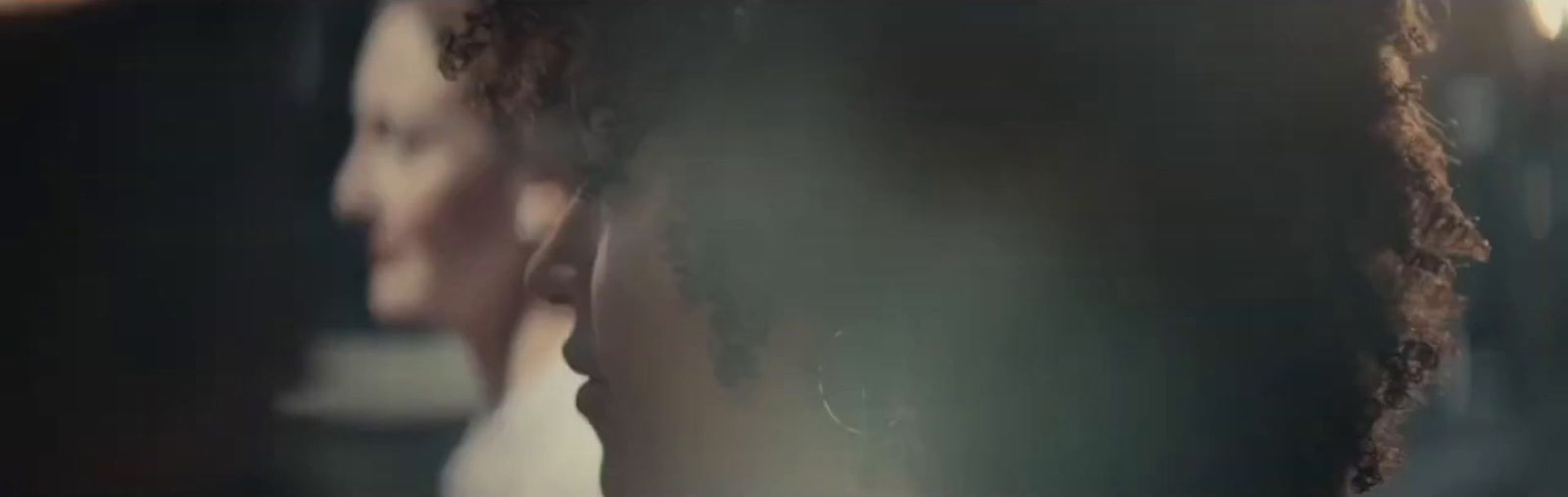 a close up of a woman's head in a mirror
