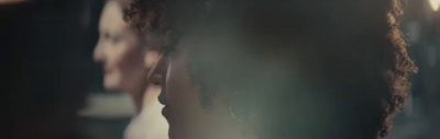 a close up of a woman's head in a mirror