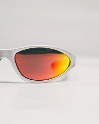 a pair of white sunglasses with red mirrored lenses