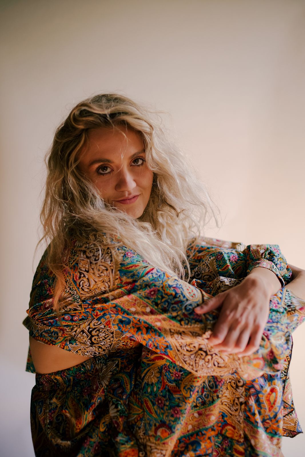 a woman in a colorful dress posing for a picture