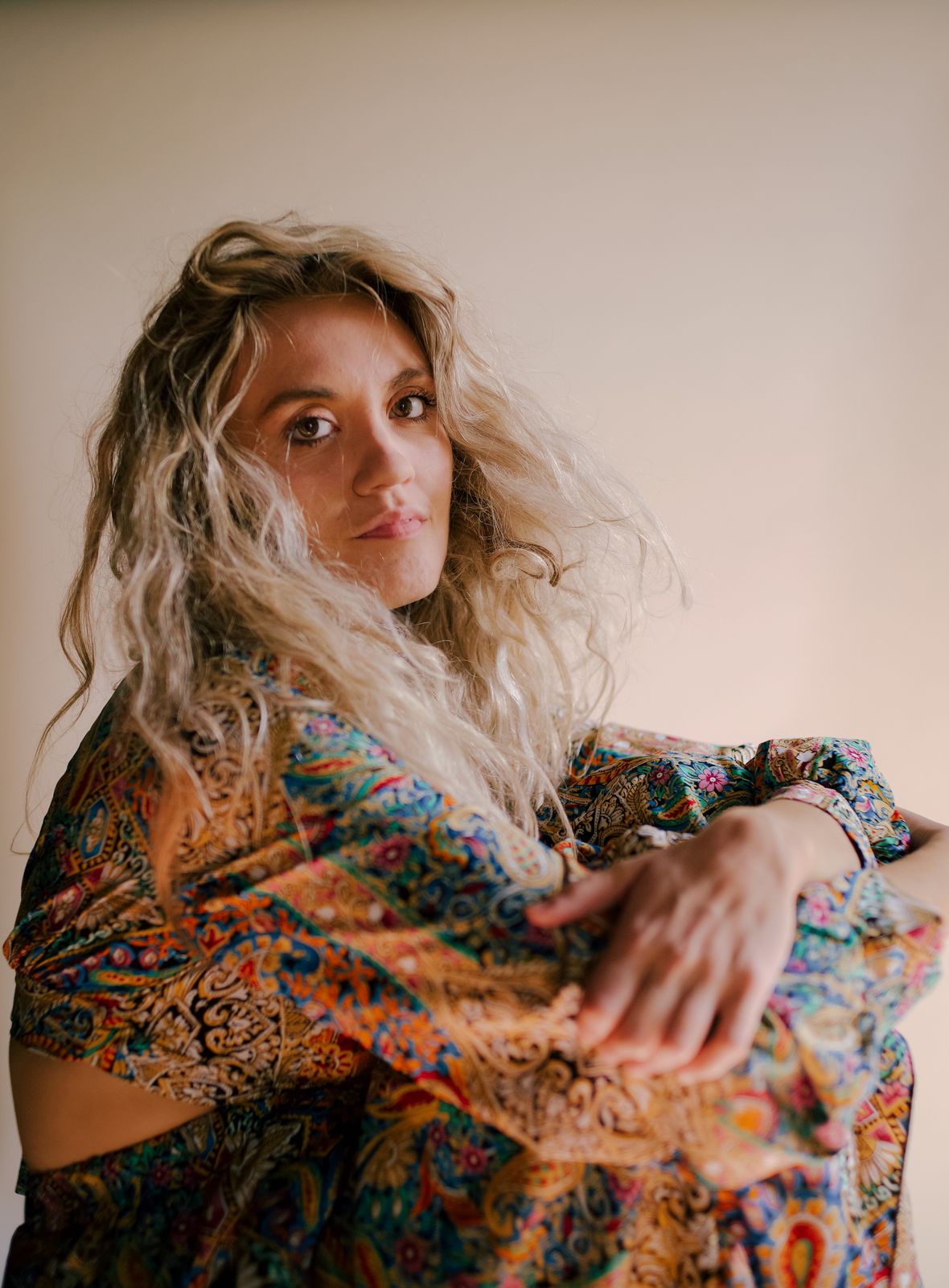 a woman in a colorful dress posing for a picture