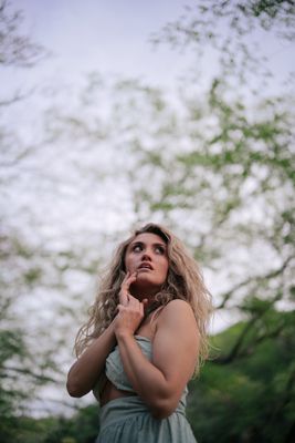 a woman in a green dress is posing for a picture