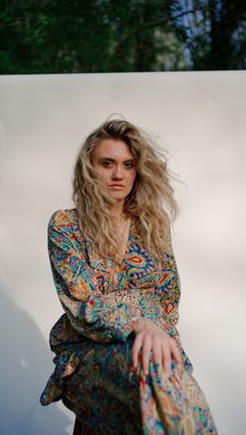 a woman in a colorful dress posing for a picture