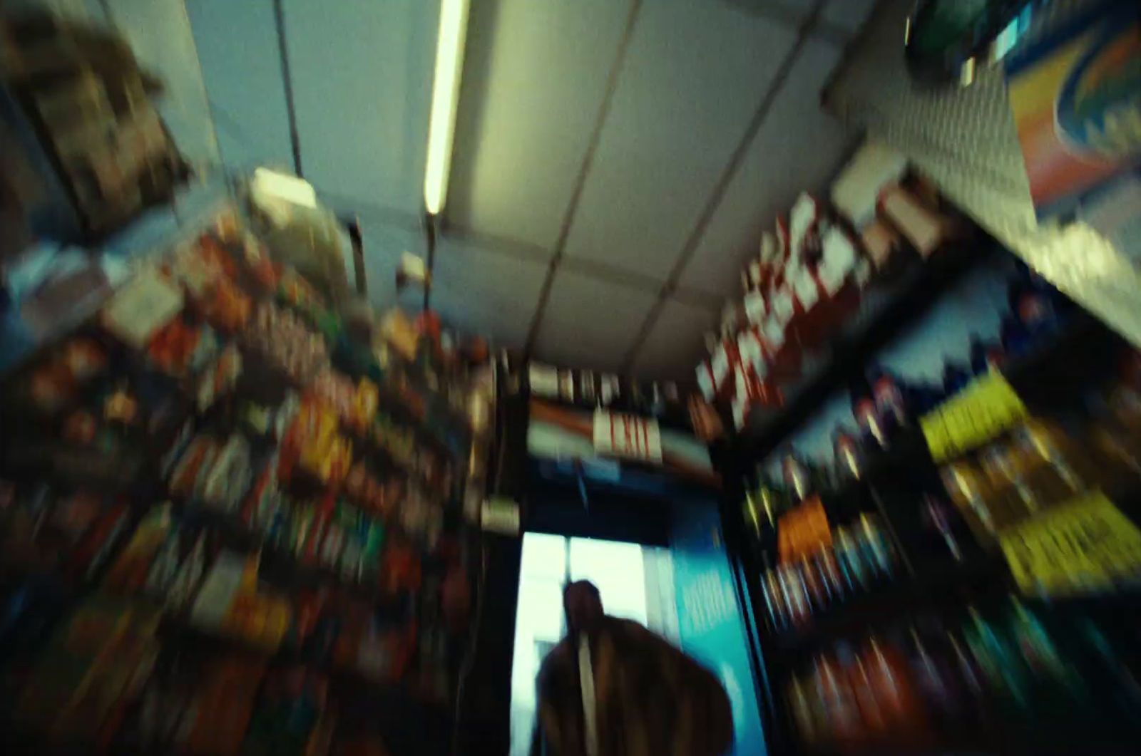 a blurry photo of a store with a person in the doorway