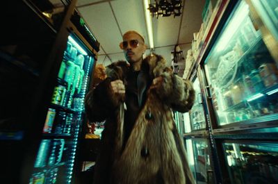 a man in a fur coat standing in a store