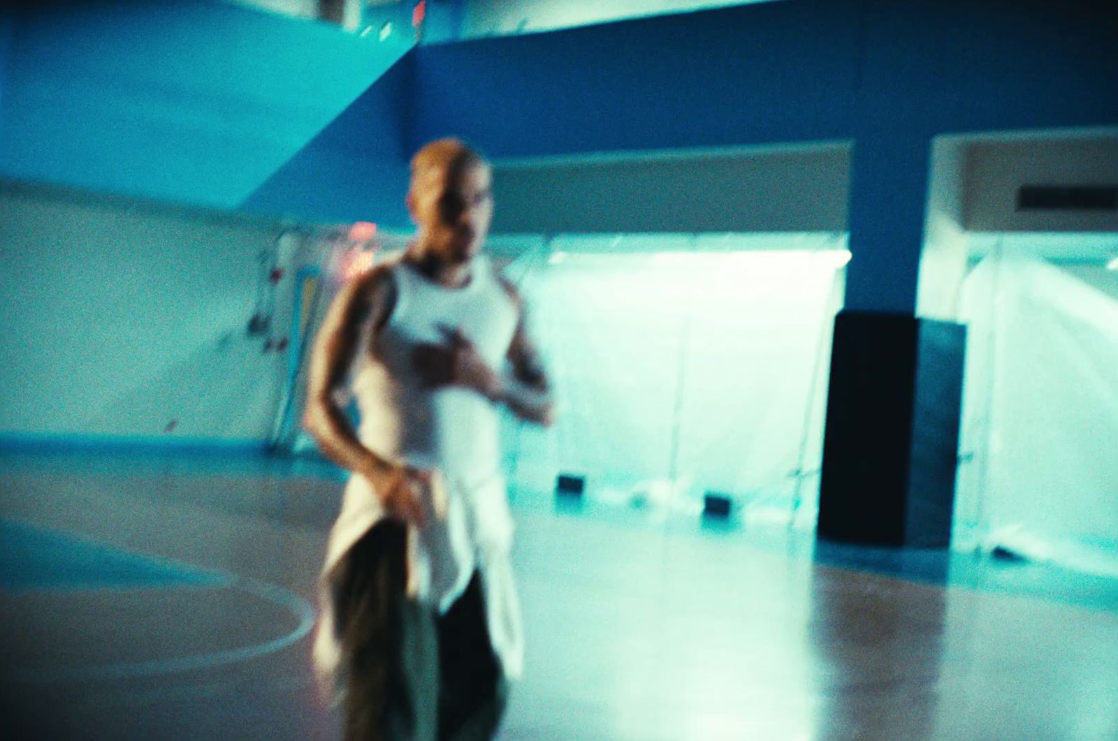 a man and a woman standing on a basketball court