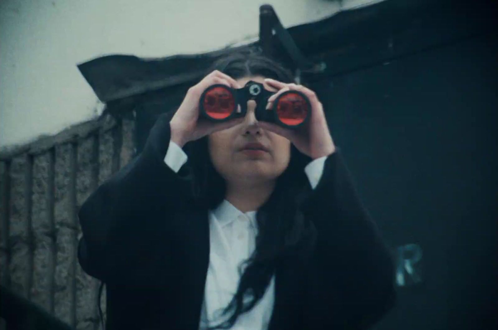 a woman looking through a pair of binoculars