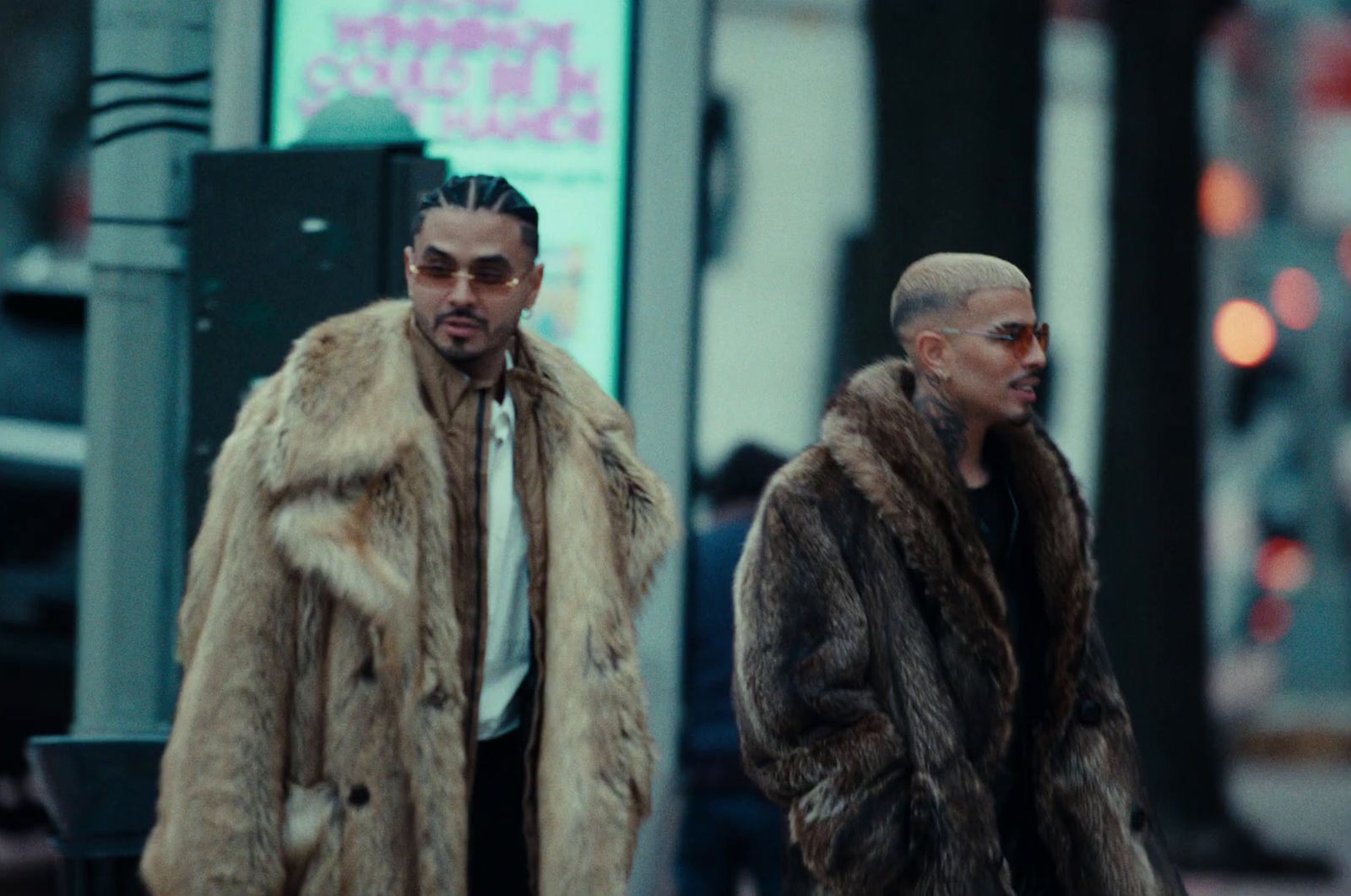 two men in fur coats walking down the street