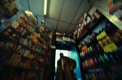 a man is walking through a store aisle