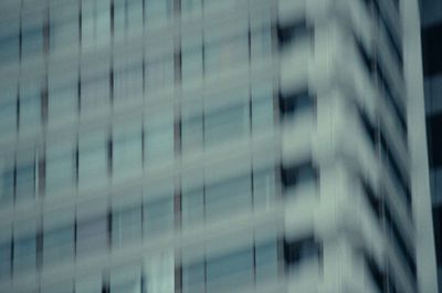 a plane flying in front of a tall building