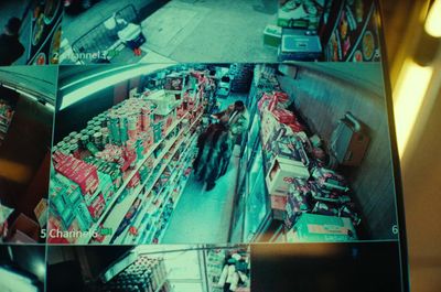 a group of people walking down a street next to a store