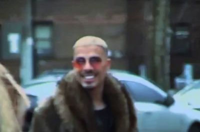 a man wearing sunglasses and a fur coat