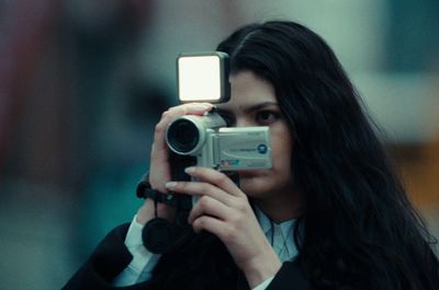 a woman taking a picture of herself with a camera