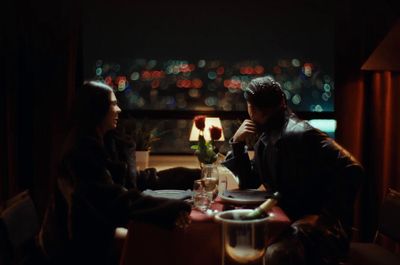 a man and a woman sitting at a table in a restaurant