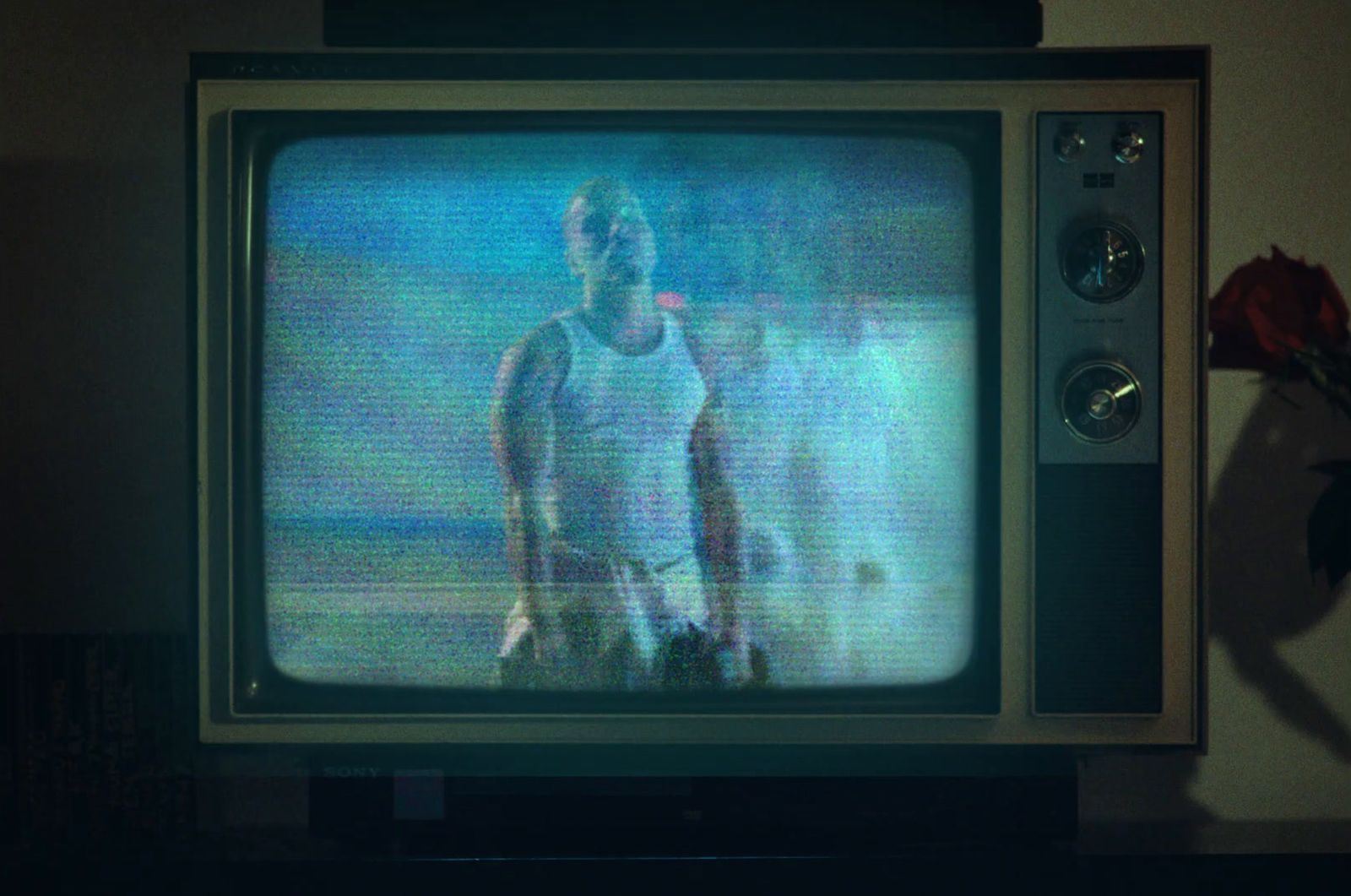 a man standing in front of a tv screen