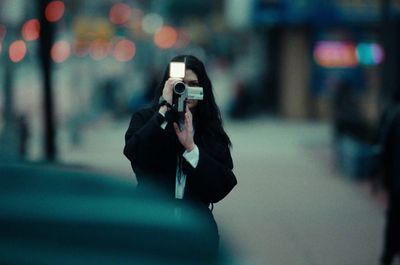 a woman taking a picture of herself with a camera