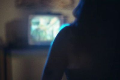 a blurry photo of a woman in front of a television