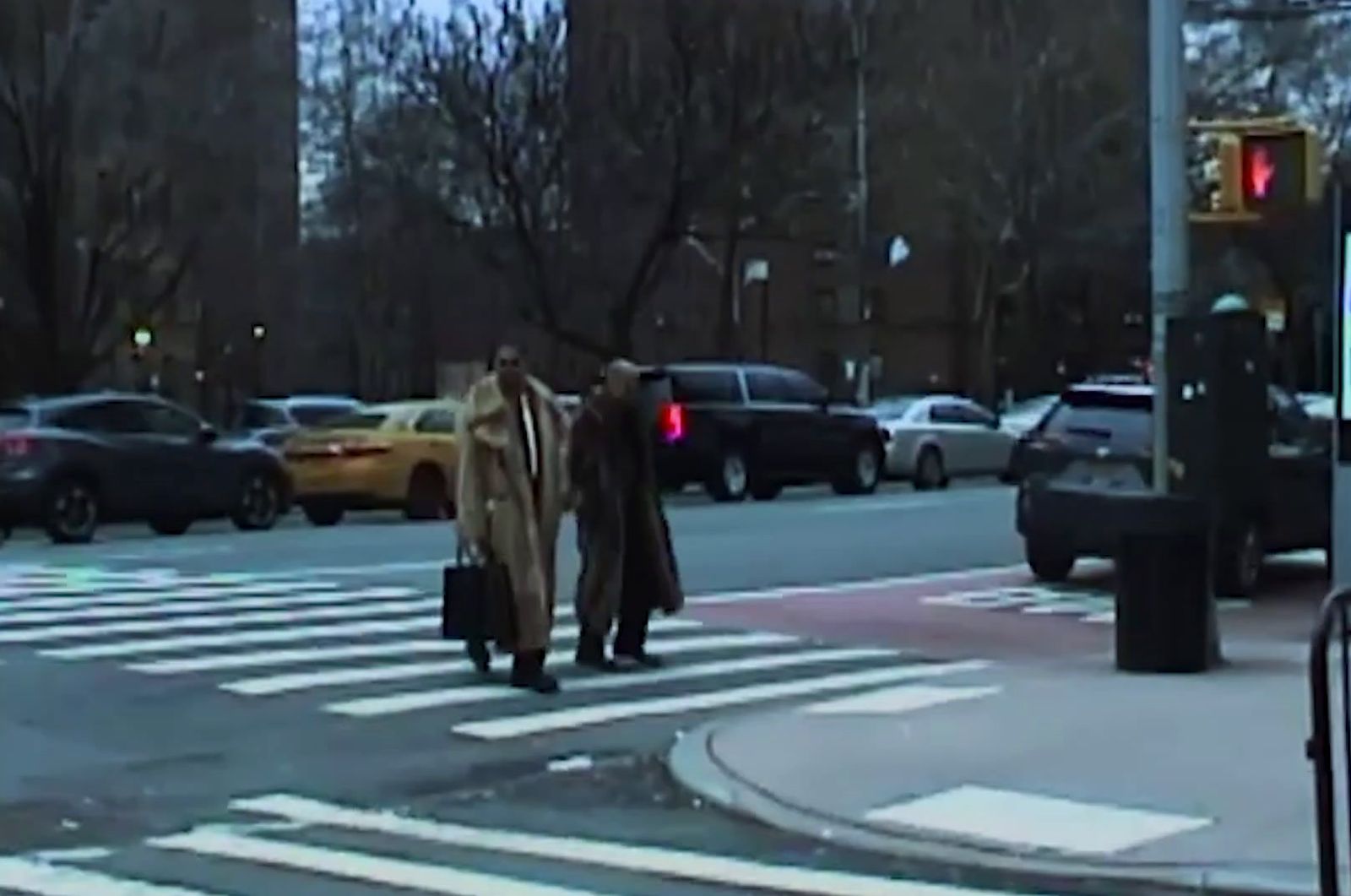 a couple of people that are walking across a street