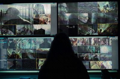 a person sitting in front of a large display of images