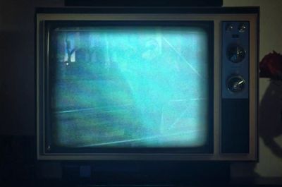 an old television with a blurry image of a person on the screen