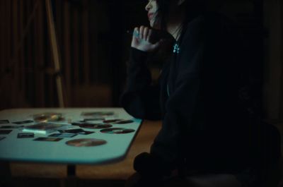 a woman sitting at a table with buttons on it