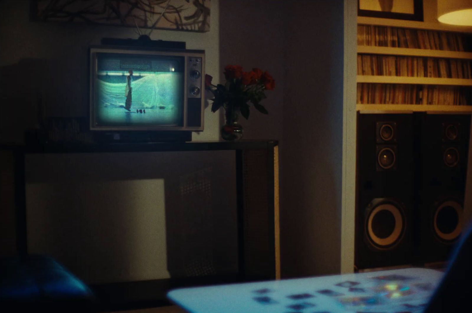 a living room with a television and speakers