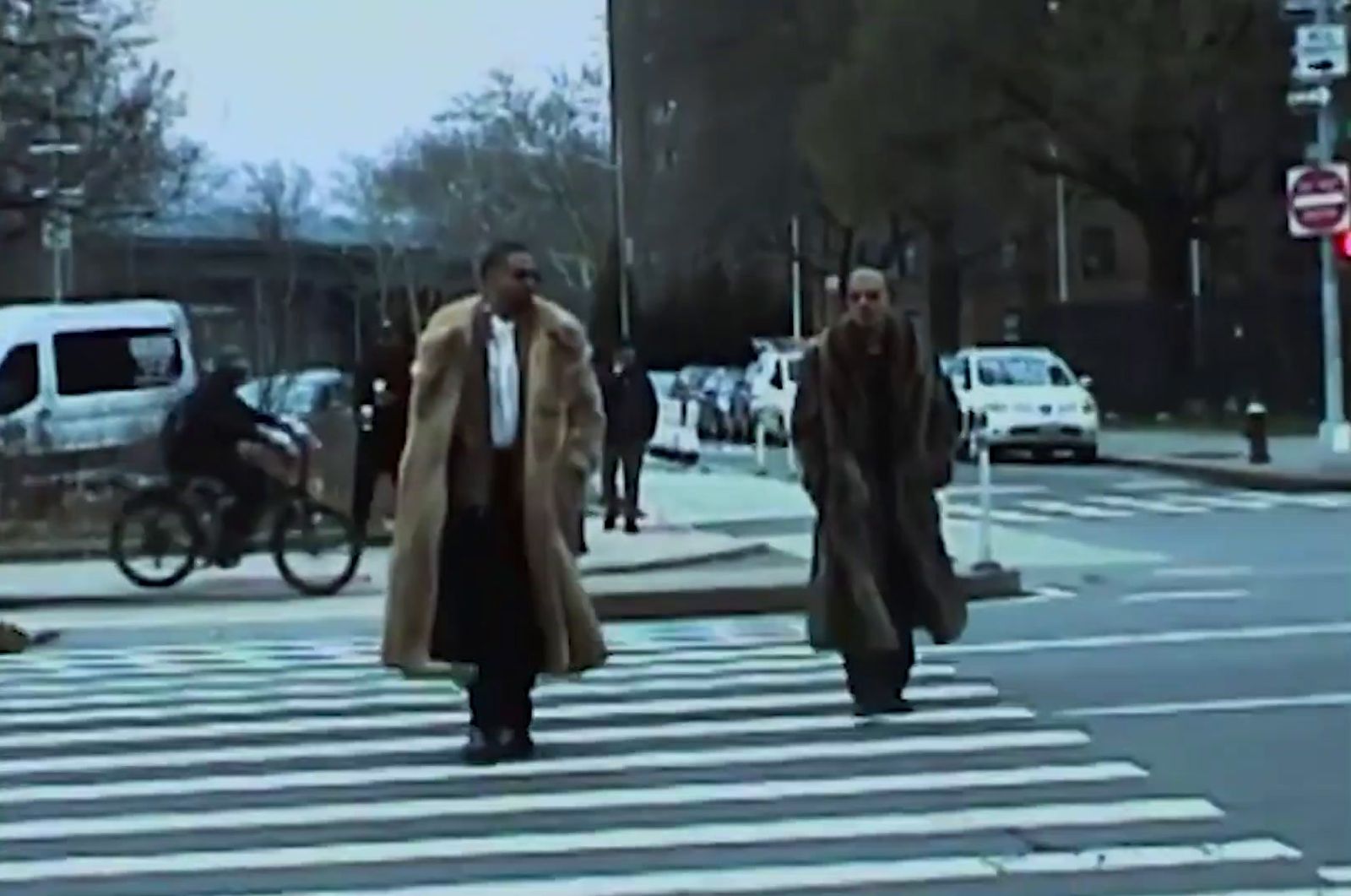 a couple of men walking across a street