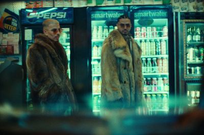 two men standing in front of a vending machine