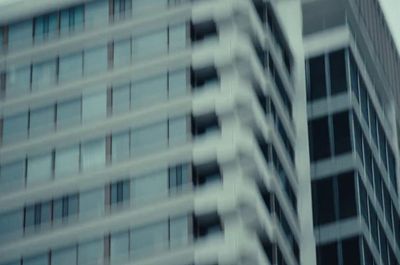 a traffic light in front of a tall building