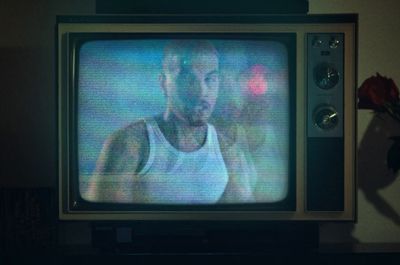 a man in a tank top is on a television