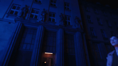 a woman standing in front of a tall building