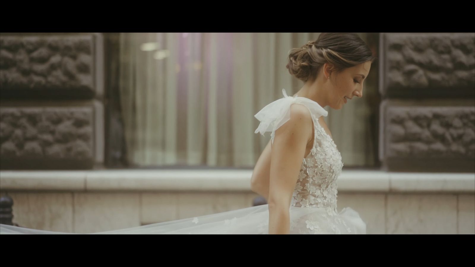 a woman in a wedding dress walking down a street