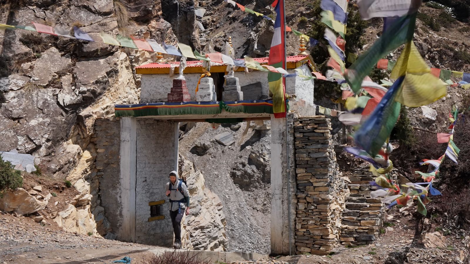 a man standing in front of a small building