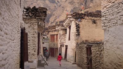 a woman in a red dress walking down a street