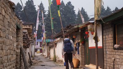 a person with a backpack walking down a street